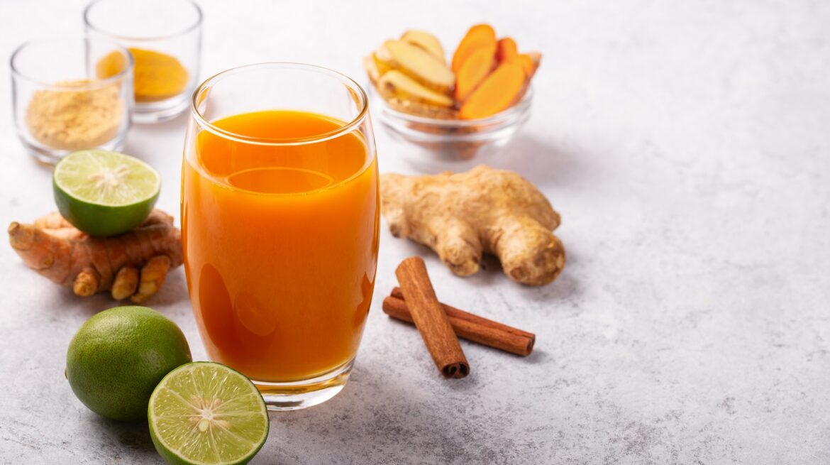 Healthy drink from turmeric and ginger roots and lime in a glass