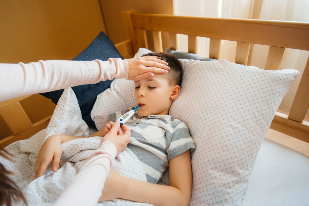 A mother takes care of her child who has a fever and fever. Disease and healthcare