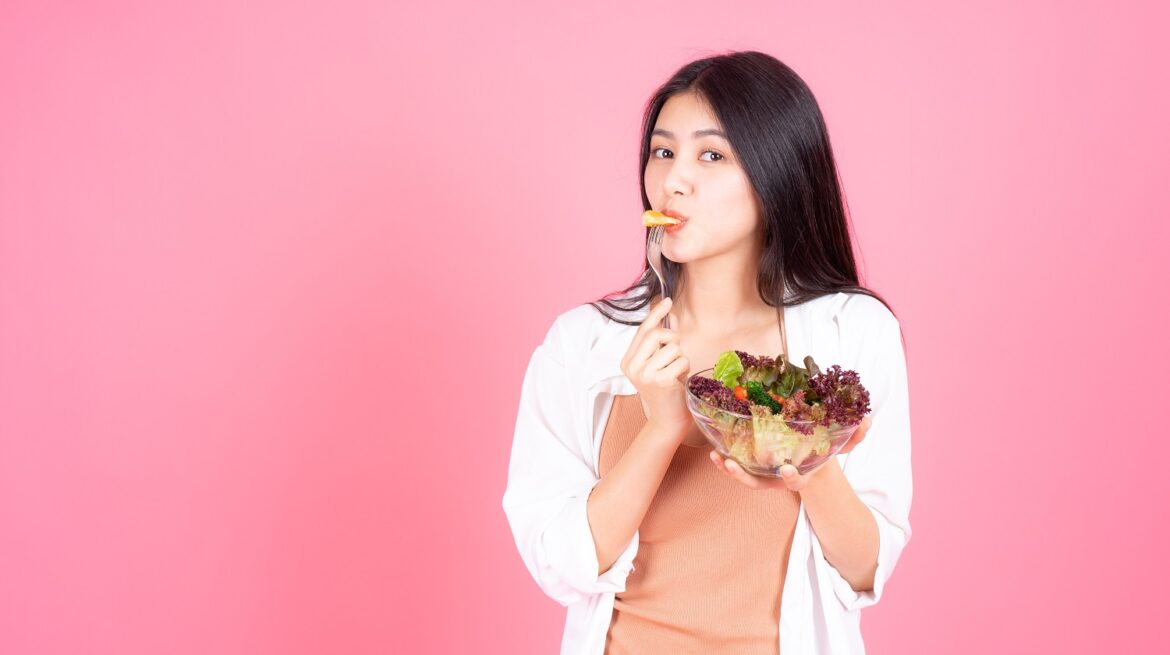 beauty-woman-asian-cute-girl-feel-happy-eating-diet-food-fresh-salad-good-health-pink-background