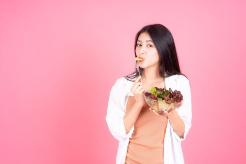 beauty-woman-asian-cute-girl-feel-happy-eating-diet-food-fresh-salad-good-health-pink-background